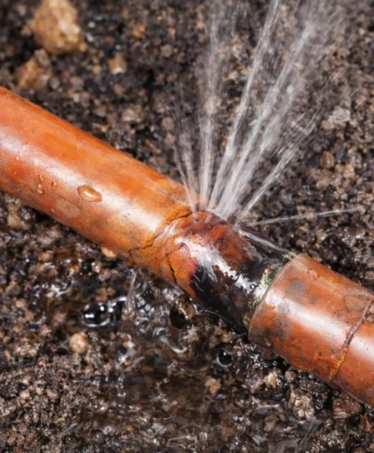 Burst copper water pipe requiring professional leak repair