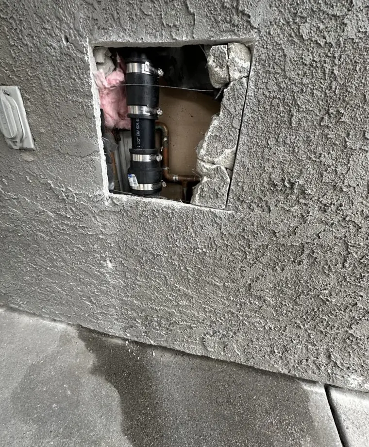 Wall access used to reconnect plumbing during a water line reroute
